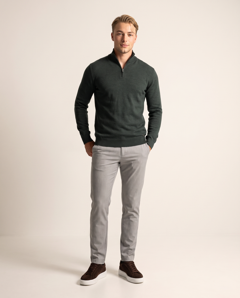 SATRI model in a forest-green funnel-neck quarter-zip knit, light grey chinos and dark brown suede trainers